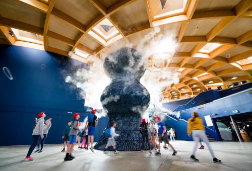 Kids running around Infinity Blue sculpture